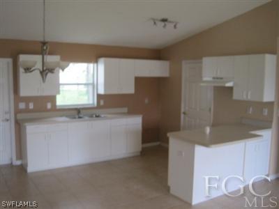 8080 Albatross Road Fort Myers, FL 33967 - Photo 2 of 2 a kitchen with cabinets and window