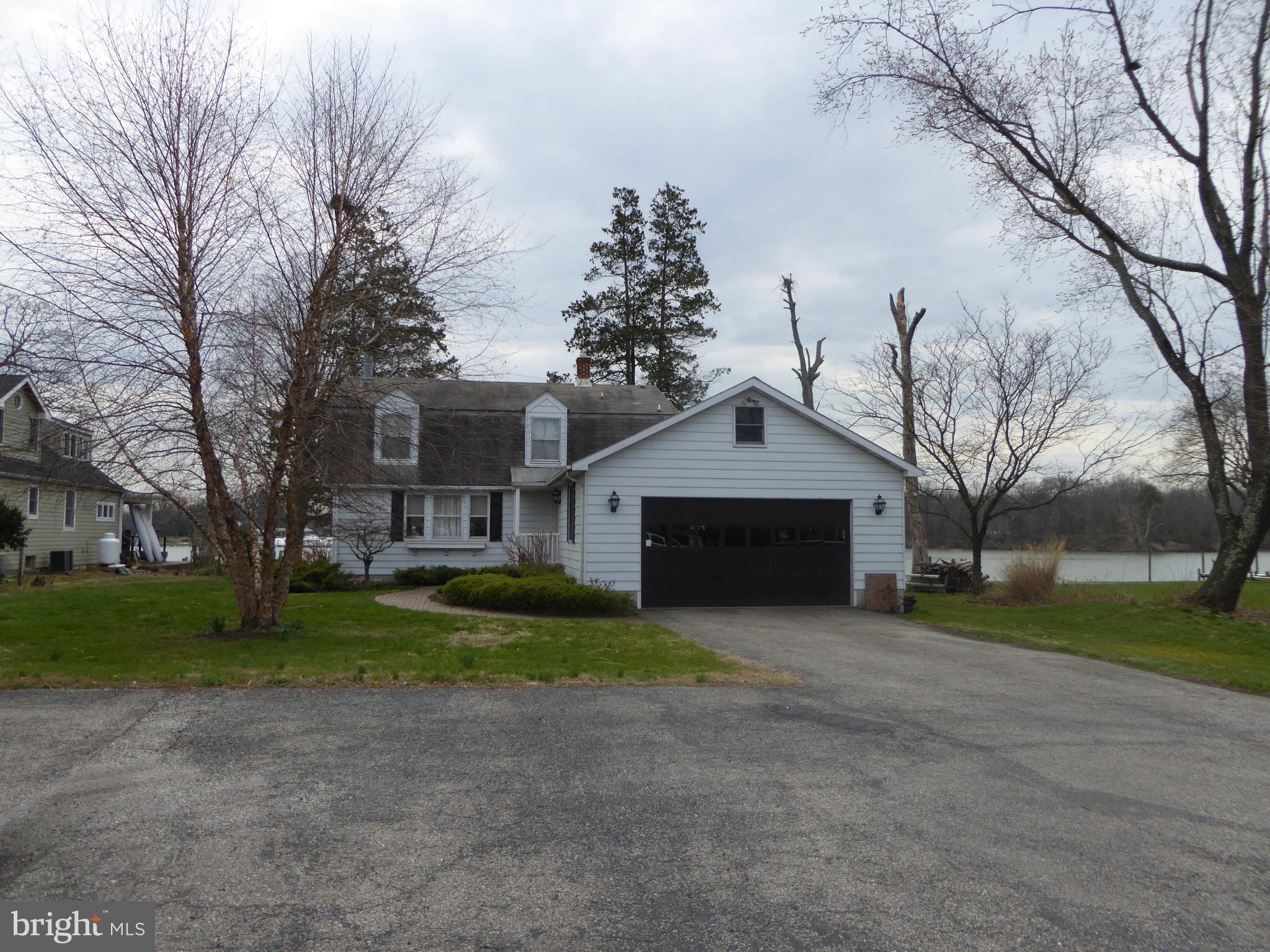 348 Miles Road Baltimore, MD 21221 - Photo 8 of 10 a view of house with a yard and large trees