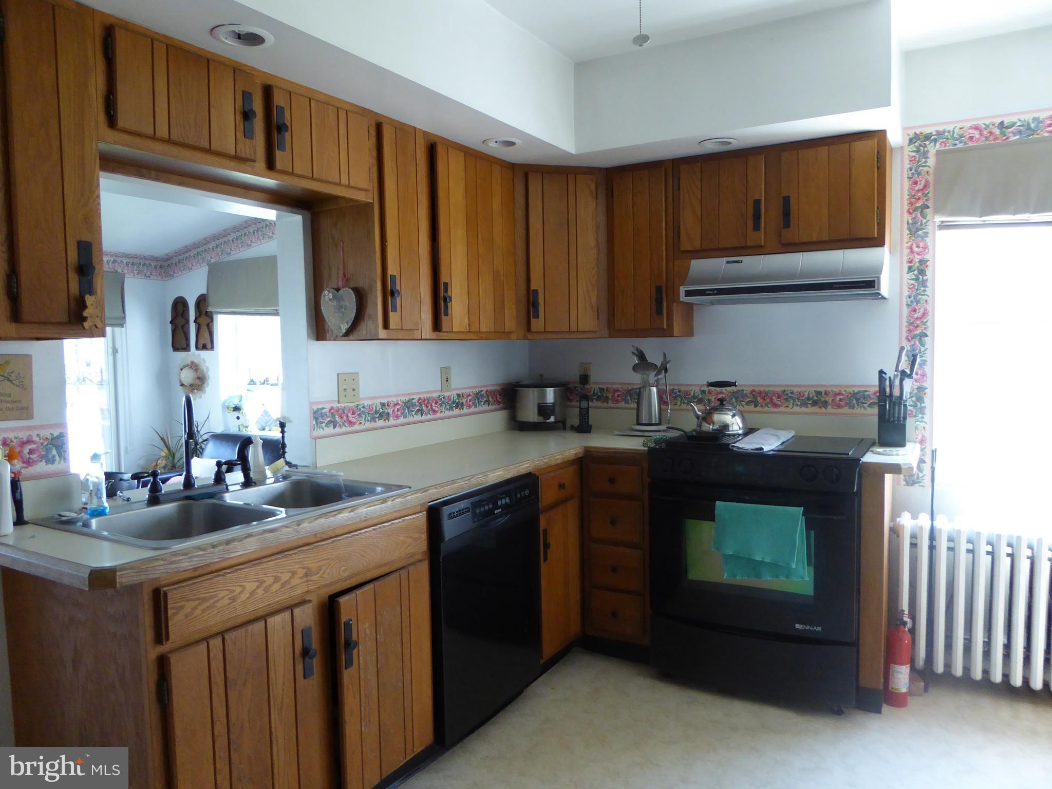 348 Miles Road Baltimore, MD 21221 - Photo 10 of 10 a kitchen with stainless steel appliances granite countertop a sink stove and cabinets