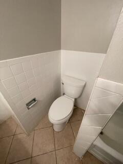5414 7th Street Lubbock, TX 79416 - Photo 9 of 11 a bathroom with a toilet and a shower