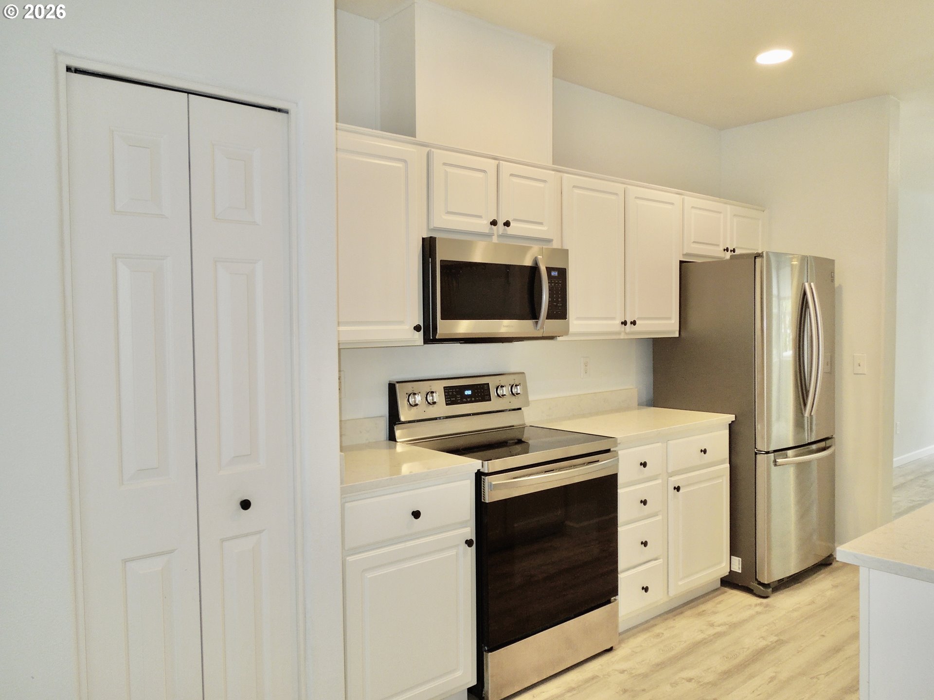 14110 Southwest Barrows Road, Unit 1 Portland, OR 97223 - Photo 5 of 18 a kitchen with stainless steel appliances a refrigerator stove and sink