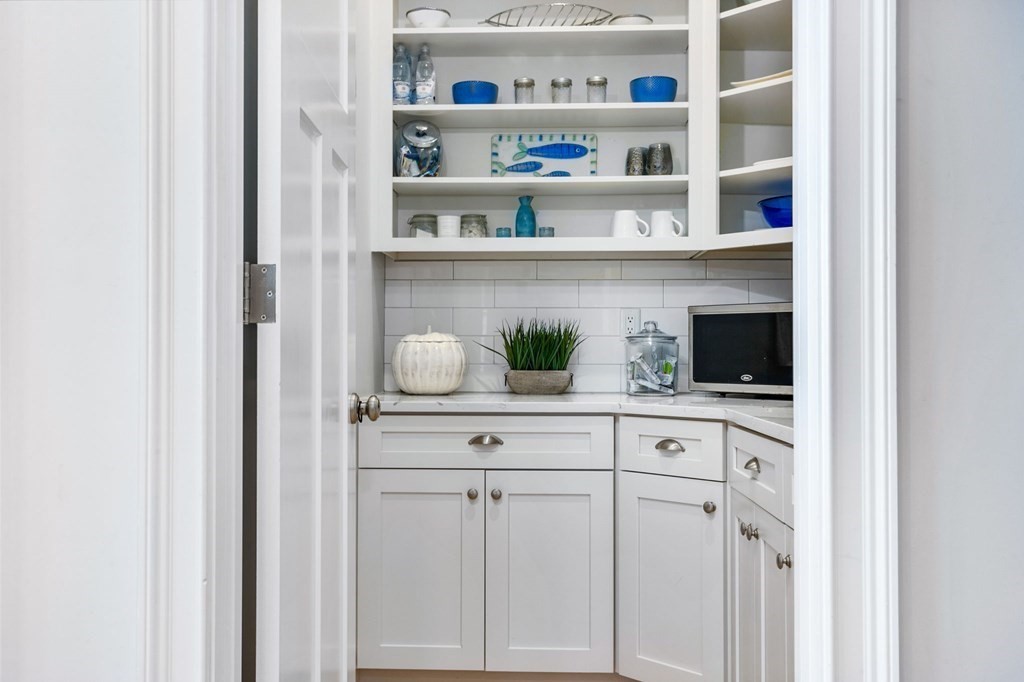 20 Collier Road Scituate, MA 02066 - Photo 12 of 42 a white kitchen with granite countertop white cabinets and a sink