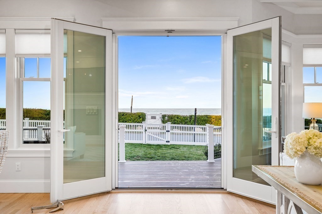 20 Collier Road Scituate, MA 02066 - Photo 13 of 42 a view of a porch with a floor to ceiling window and wooden floor