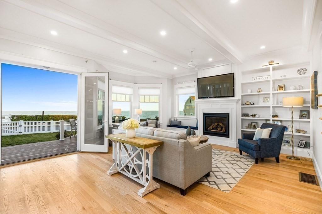 20 Collier Road Scituate, MA 02066 - Photo 14 of 42 a living room with fireplace furniture and a floor to ceiling window