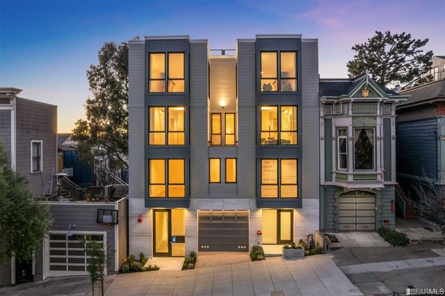front view of a brick house with a large window
