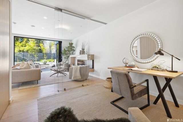 a view of a backyard with plants and barbeque grill