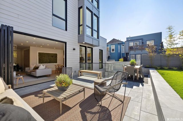 a kitchen with a table chairs refrigerator and cabinets