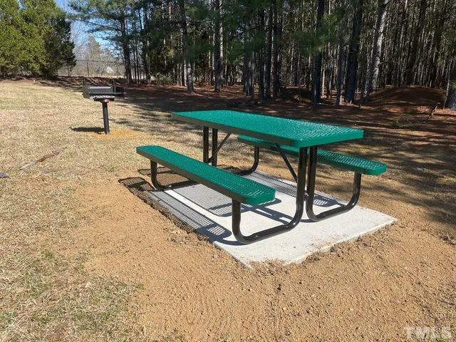 a park view with wooden fence and trees