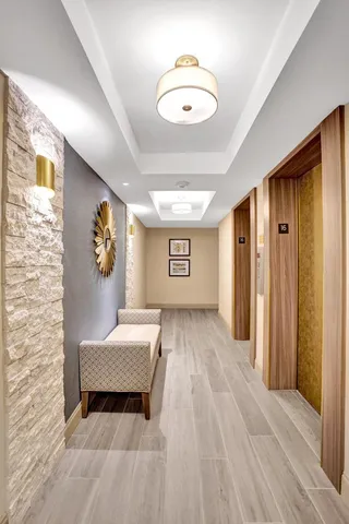 a view of a bedroom with wooden floor and windows