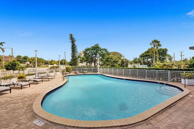 a view of a swimming pool with a lounge chair