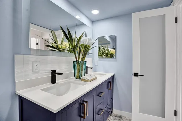 a bathroom with a sink a mirror and window