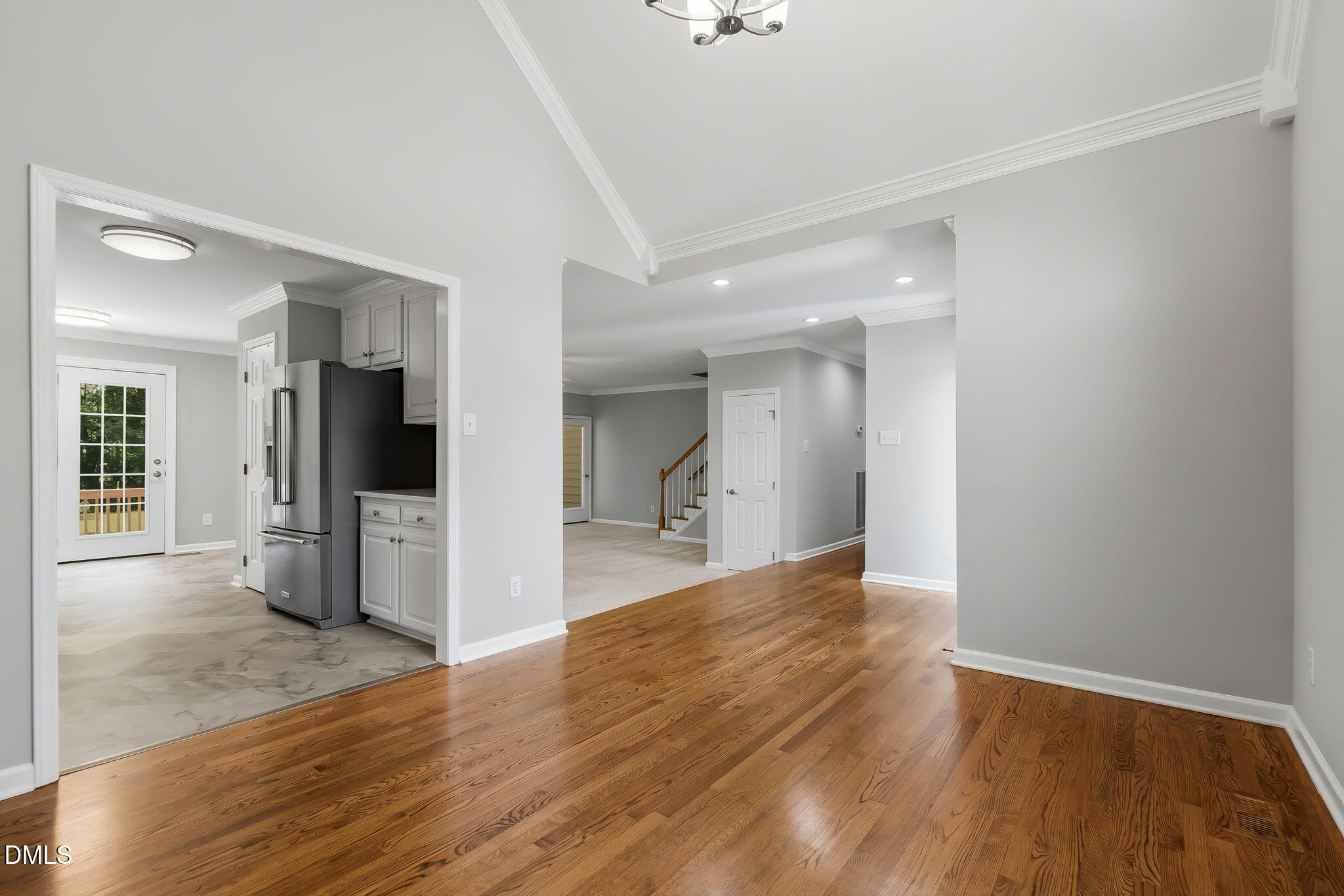 1112 Tyler Farms Drive Raleigh, NC 27603 - Photo 19 of 78 a view of a hallway with wooden floor and a living room