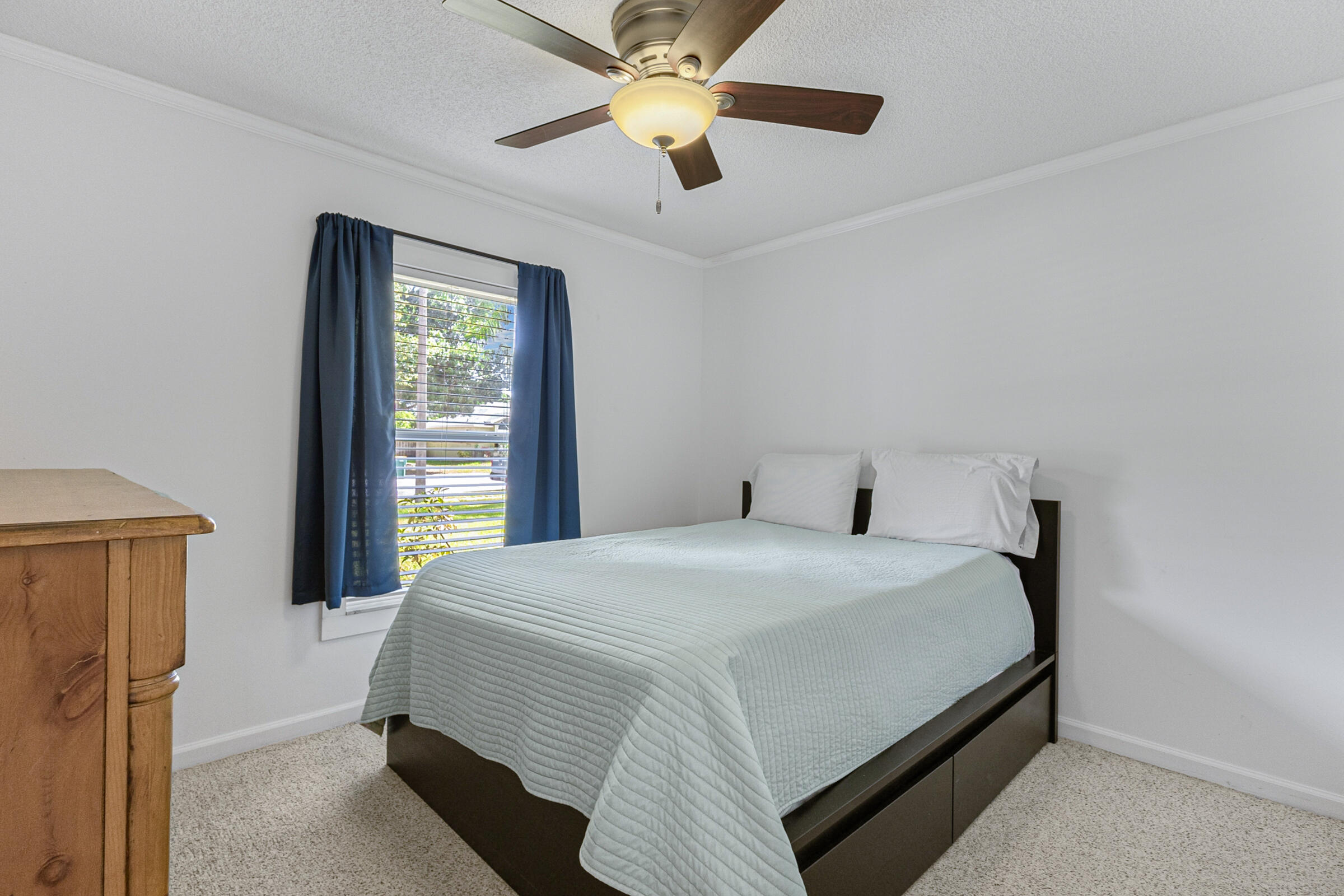 141 Crystal Lake Road Melbourne, FL 32901 - Photo 11 of 44 a bedroom with a bed and a chandelier