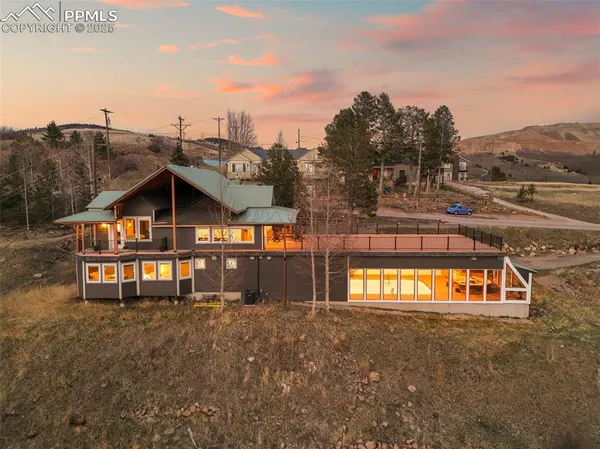 a view of a house with a yard and sitting area