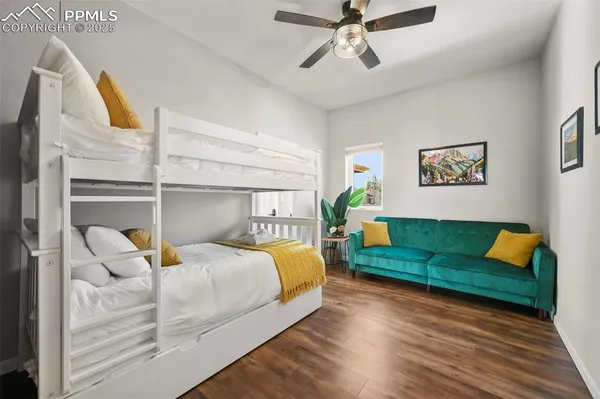 a bedroom with a bed and wooden floor