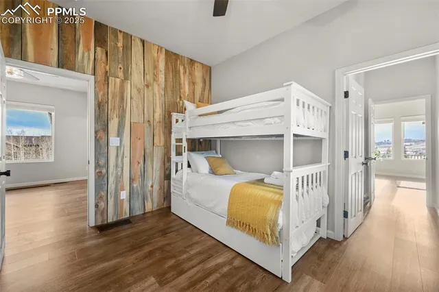 a bathroom with a granite countertop sink a mirror and a shower