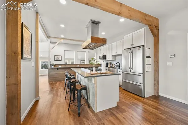 a kitchen with stainless steel appliances granite countertop a stove and a refrigerator