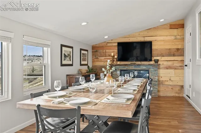 a front view of a house with large trees