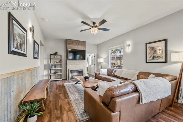 a living room with furniture and a wooden floor