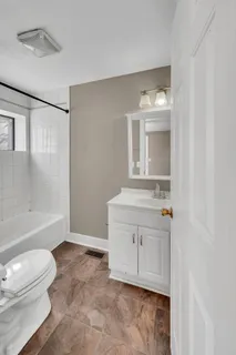 a view of bathroom with a toilet sink bath tub and shower