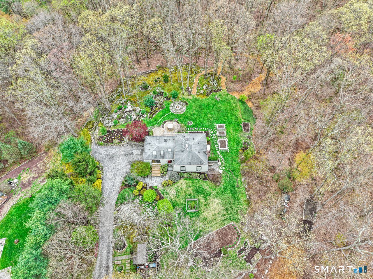 86 Seventy Acre Road Redding, CT 06896 - Photo 2 of 40 a plant that is in front of a yard