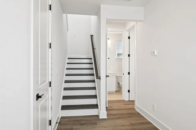 a big room with wooden floor and windows