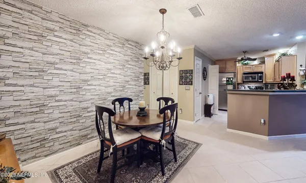 a view of a dining room with furniture and chandelier