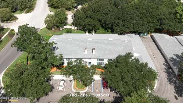 an aerial view of a house with outdoor space and street view