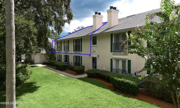 an aerial view of a house with a yard swimming pool and outdoor seating