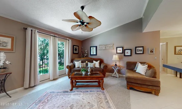 a living room with furniture and a chandelier