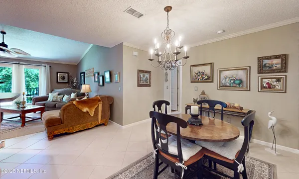 a living room with furniture a fireplace and a chandelier