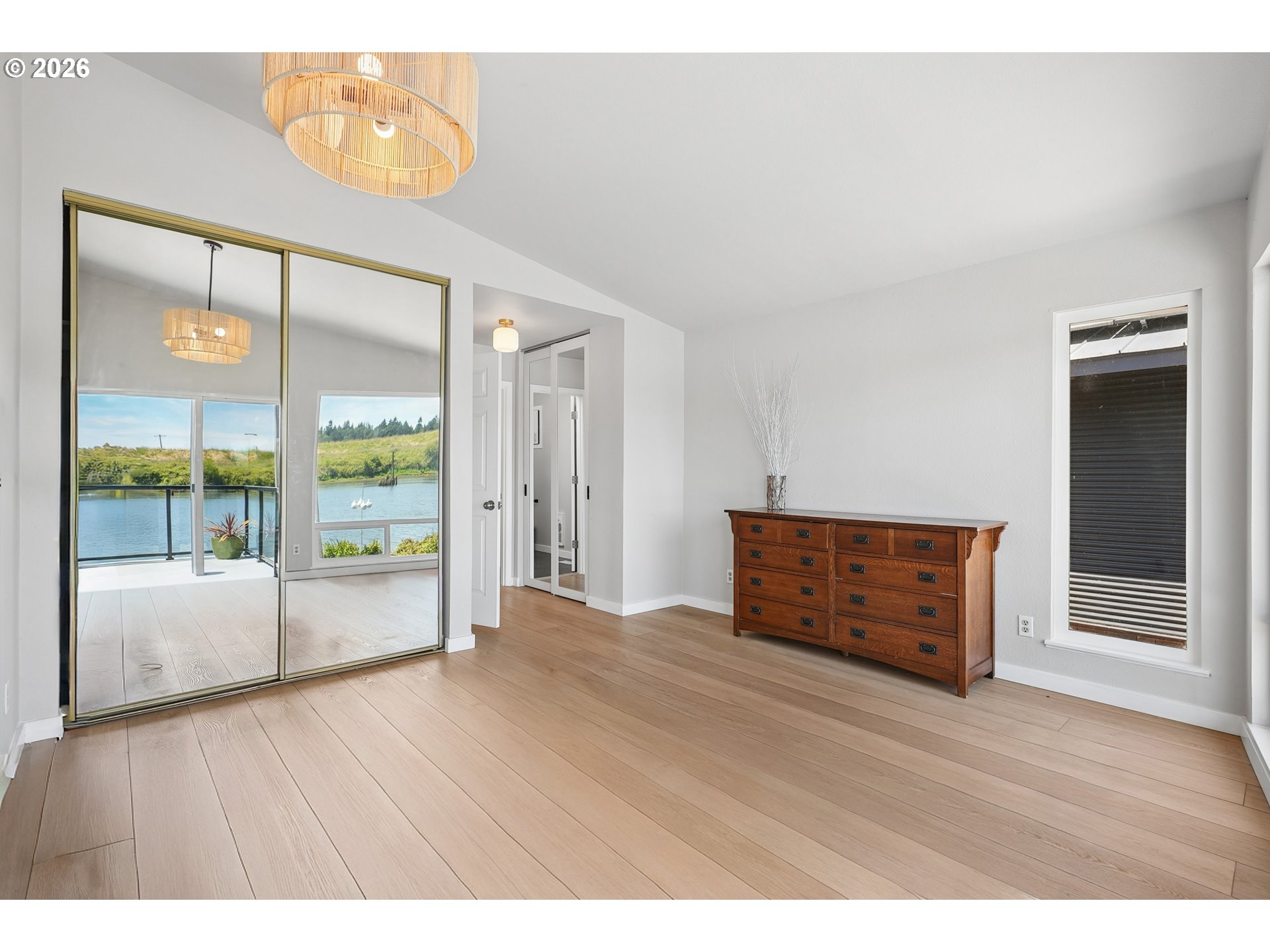 14936 Northwest Mill Road, Unit K Portland, OR 97231 - Photo 23 of 33 an empty room with wooden floor and windows
