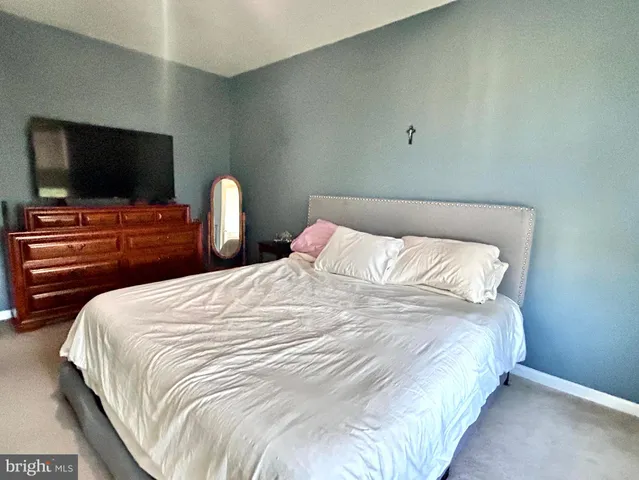 a spacious bathroom with a double vanity sink toilet and a mirror