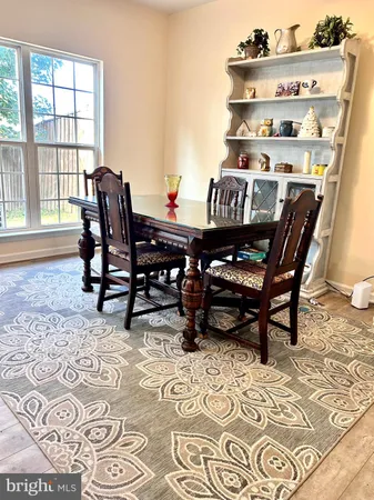 a dining room with furniture and wooden floor