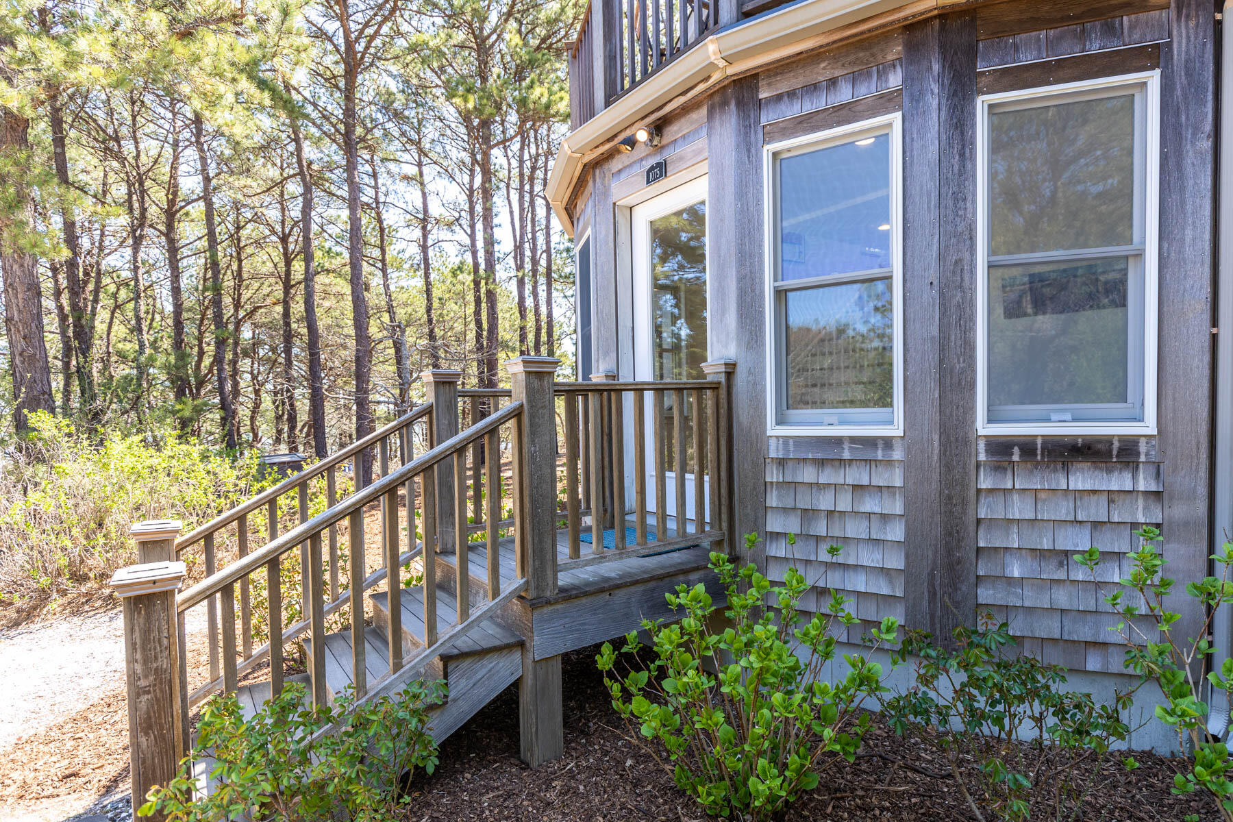 1075 3rd Avenue Wellfleet, MA 02667 - Photo 13 of 87 a view of a house with large windows and a small yard