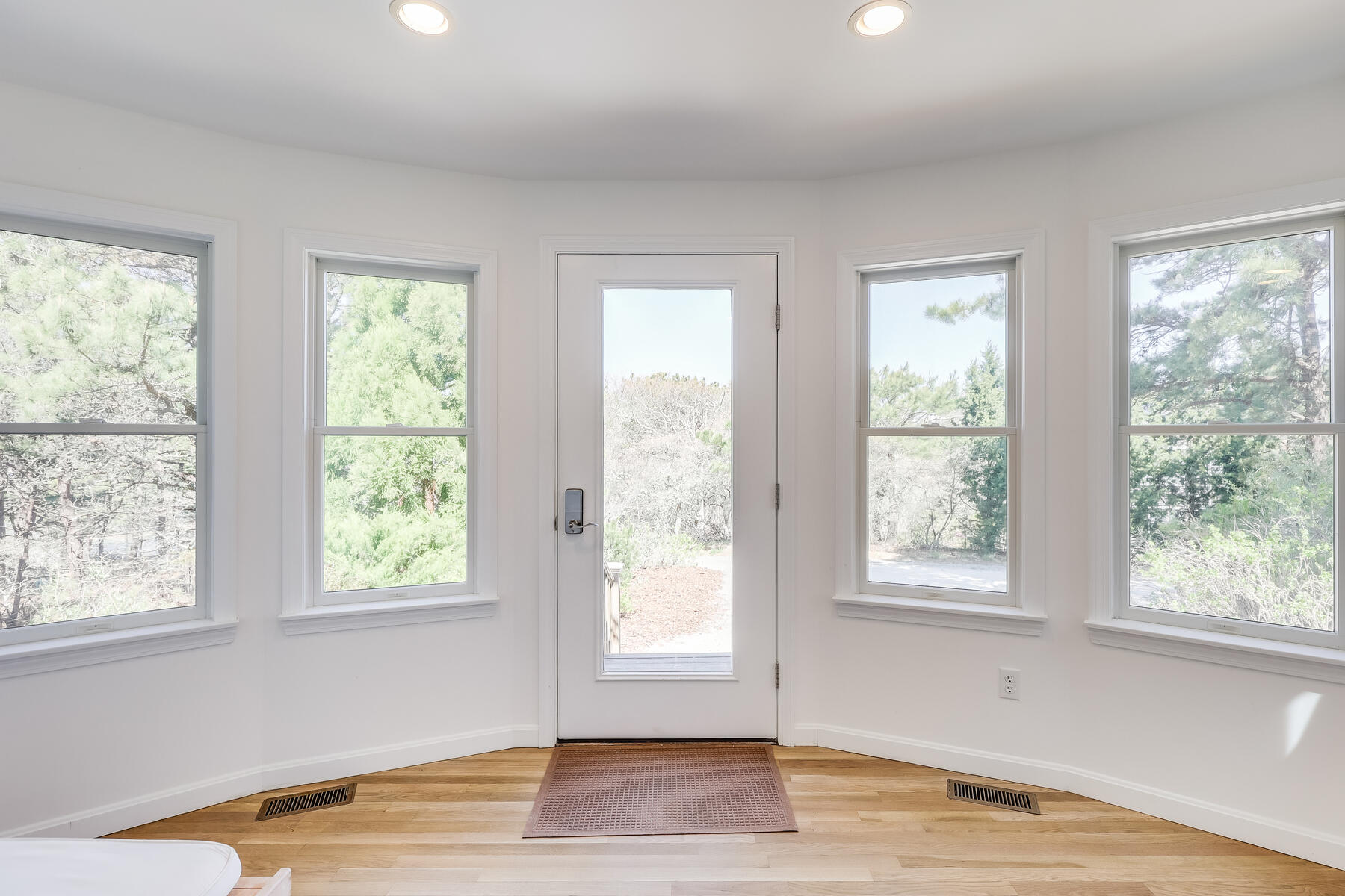 1075 3rd Avenue Wellfleet, MA 02667 - Photo 14 of 87 a view of an empty room with wooden floor and a window