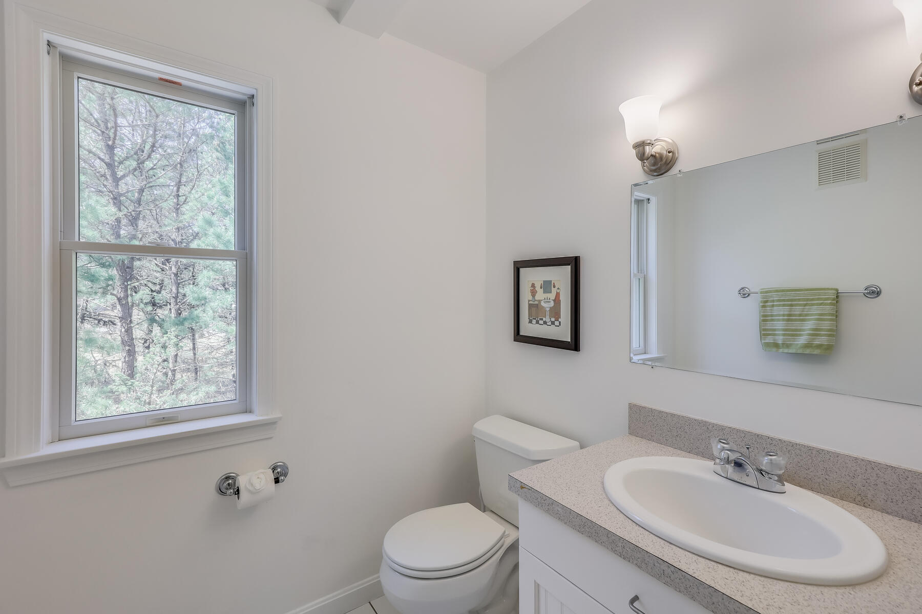 1075 3rd Avenue Wellfleet, MA 02667 - Photo 67 of 87 a bathroom with a toilet a sink a mirror and a window