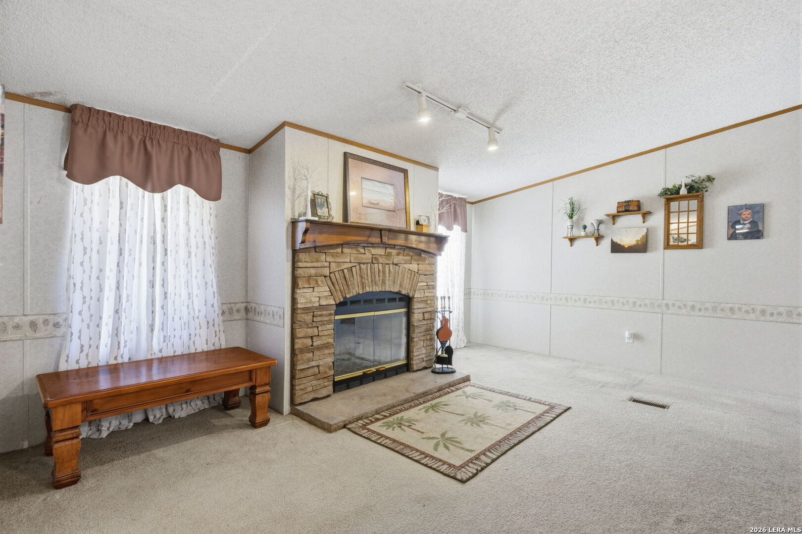 708 Mesquite Street Jourdanton, TX 78026 - Photo 11 of 49 a living room with furniture and a fireplace