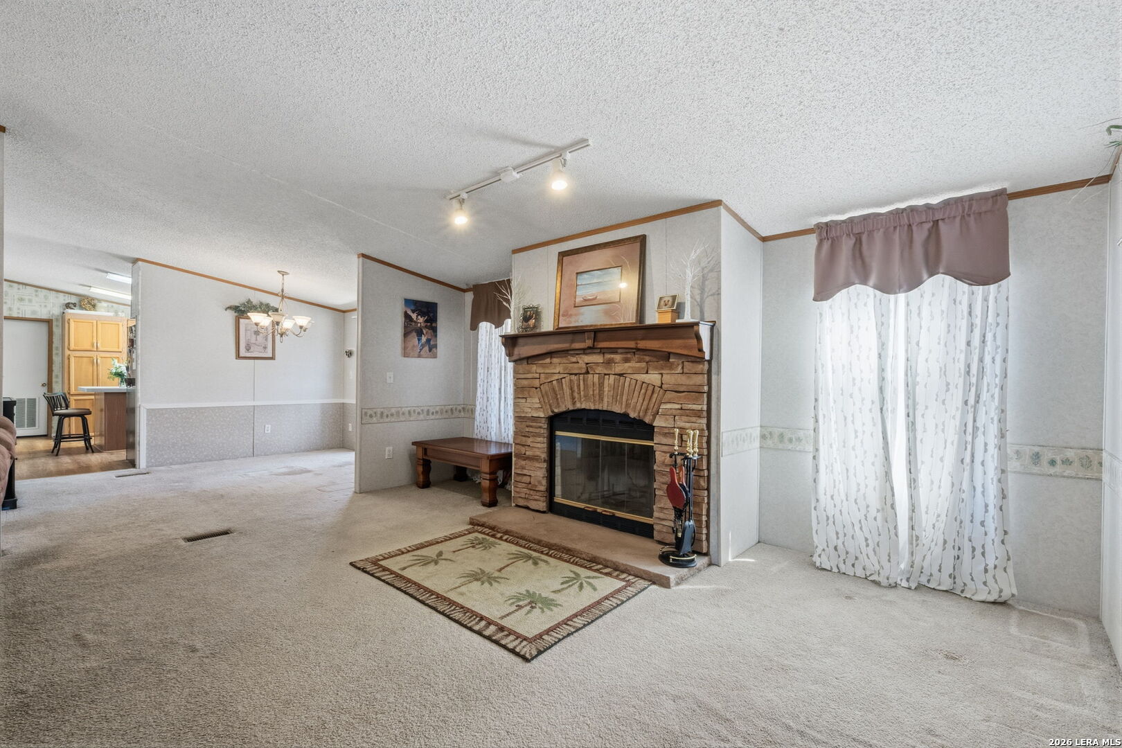 708 Mesquite Street Jourdanton, TX 78026 - Photo 12 of 49 a living room with furniture and a fireplace