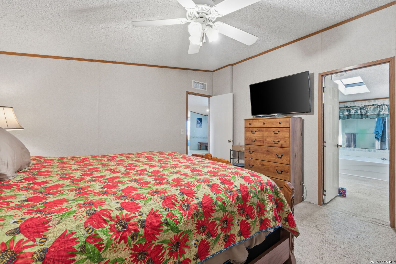 708 Mesquite Street Jourdanton, TX 78026 - Photo 22 of 49 a bedroom with a bed and a flat screen tv