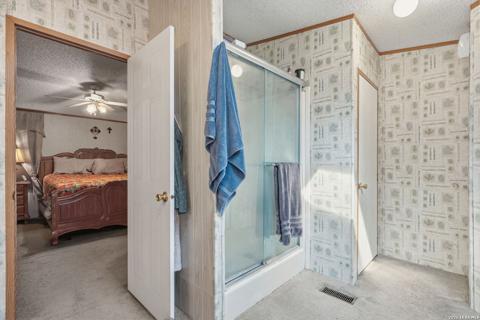 708 Mesquite Street Jourdanton, TX 78026 - Photo 25 of 49 a en suite bathroom with a shower and a sink