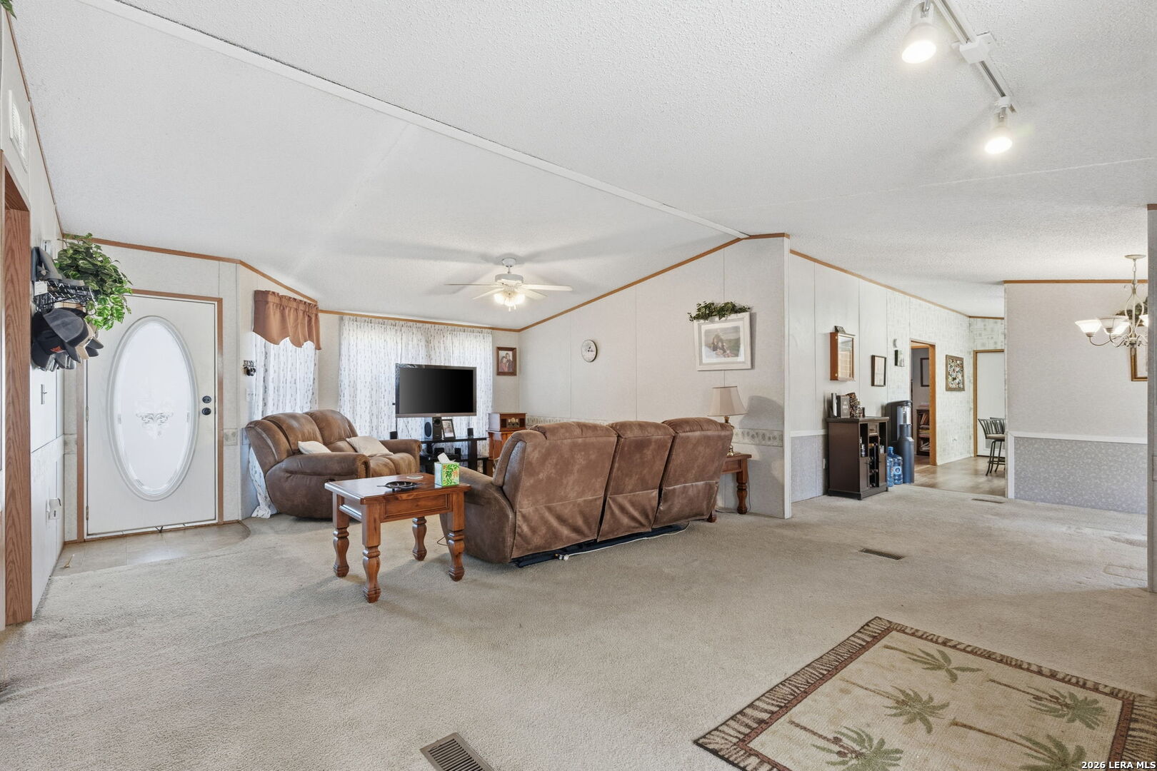 708 Mesquite Street Jourdanton, TX 78026 - Photo 7 of 49 a living room with furniture and a flat screen tv