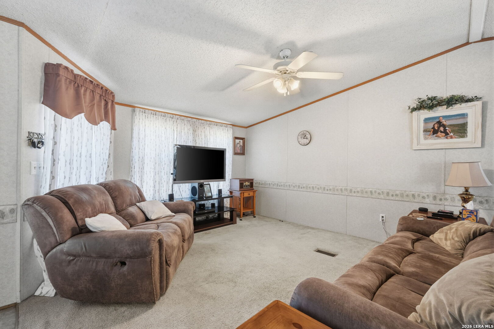 708 Mesquite Street Jourdanton, TX 78026 - Photo 8 of 49 a living room with furniture and a flat screen tv