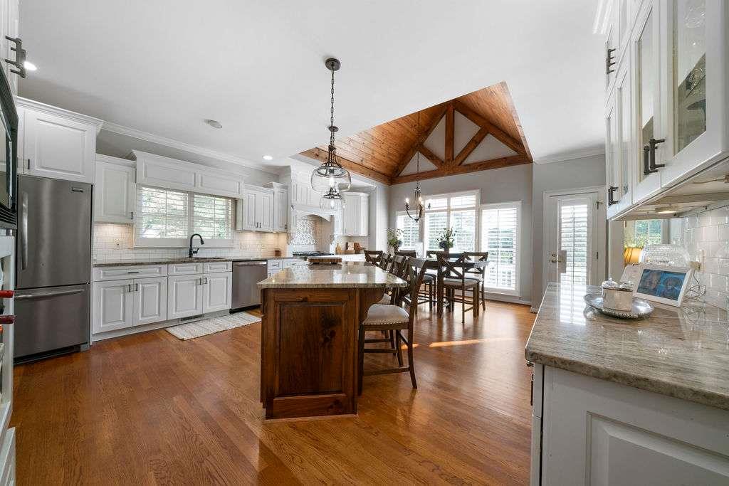 111 Warwick Way Rome, GA 30161 - Photo 11 of 46 a kitchen with stainless steel appliances granite countertop a refrigerator a sink dishwasher a stove and a dining table with wooden floor