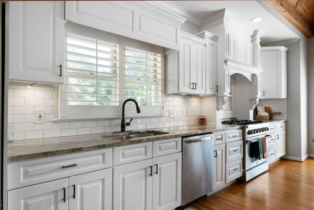 111 Warwick Way Rome, GA 30161 - Photo 13 of 46 a kitchen with white cabinets and a window