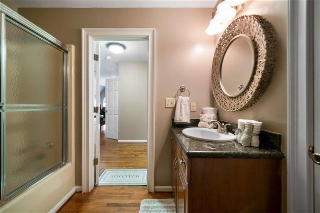 111 Warwick Way Rome, GA 30161 - Photo 25 of 46 a bathroom with a granite countertop sink and a mirror