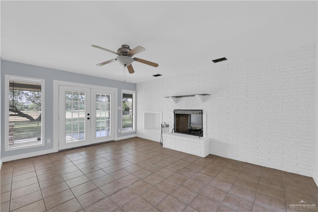 314 Santa Ana Avenue Rancho Viejo, TX 78575 - Photo 13 of 30 an empty room with windows and fireplace