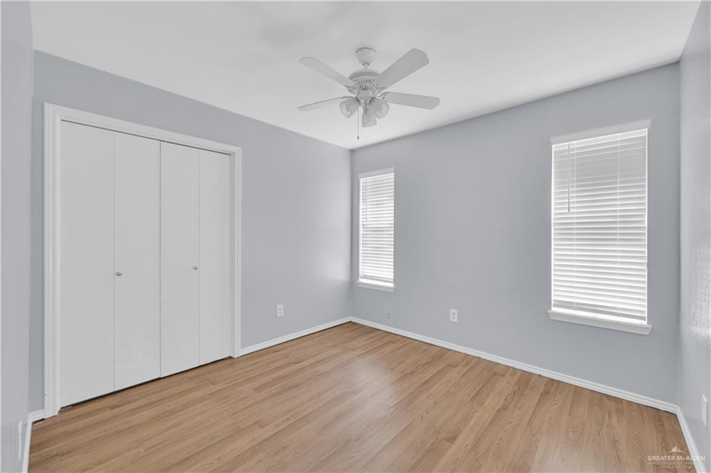 314 Santa Ana Avenue Rancho Viejo, TX 78575 - Photo 17 of 30 a view of an empty room with wooden floor and a window