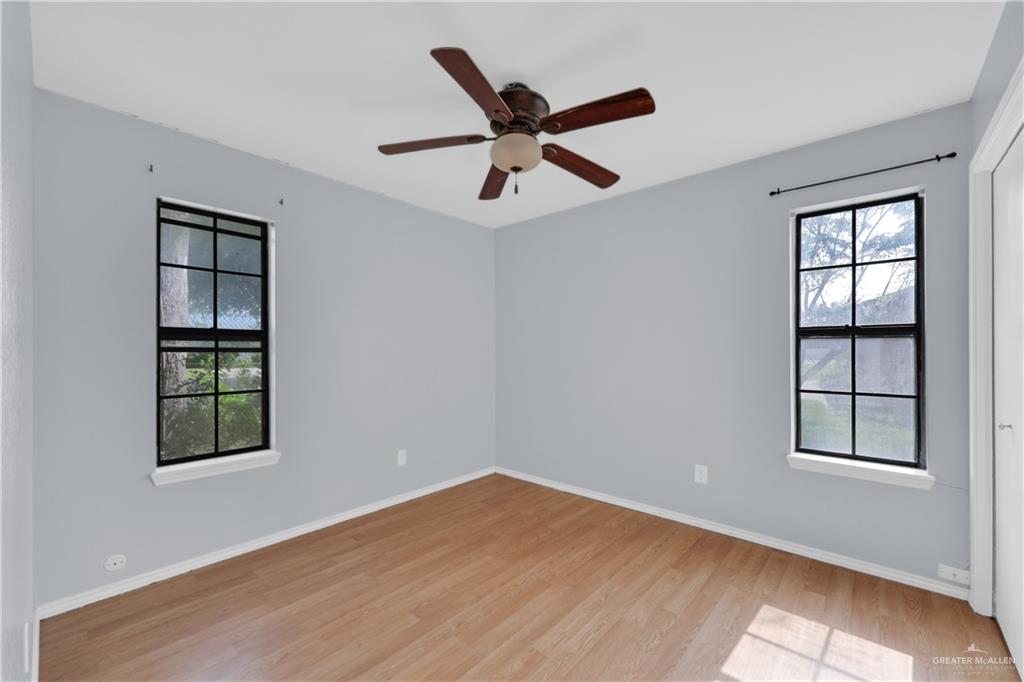 314 Santa Ana Avenue Rancho Viejo, TX 78575 - Photo 18 of 30 an empty room with windows and ceiling fan