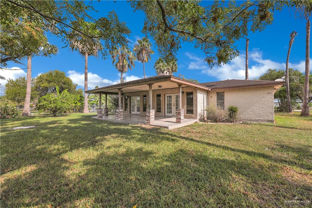314 Santa Ana Avenue Rancho Viejo, TX 78575 - Photo 19 of 30 a front view of a house with a garden